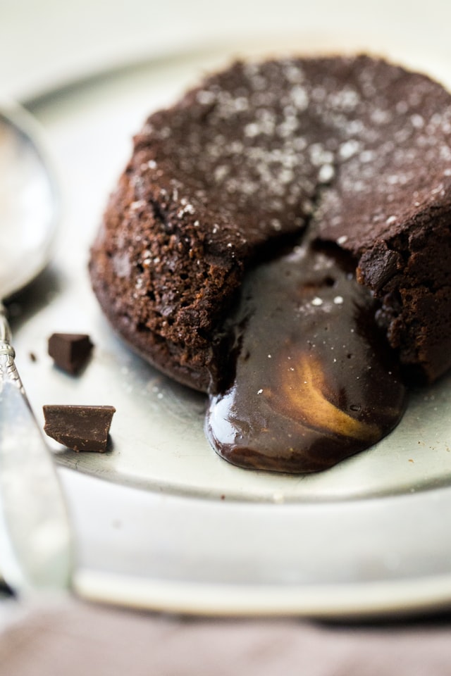 Chocolate oozes from a serving of molten chocolate cake.